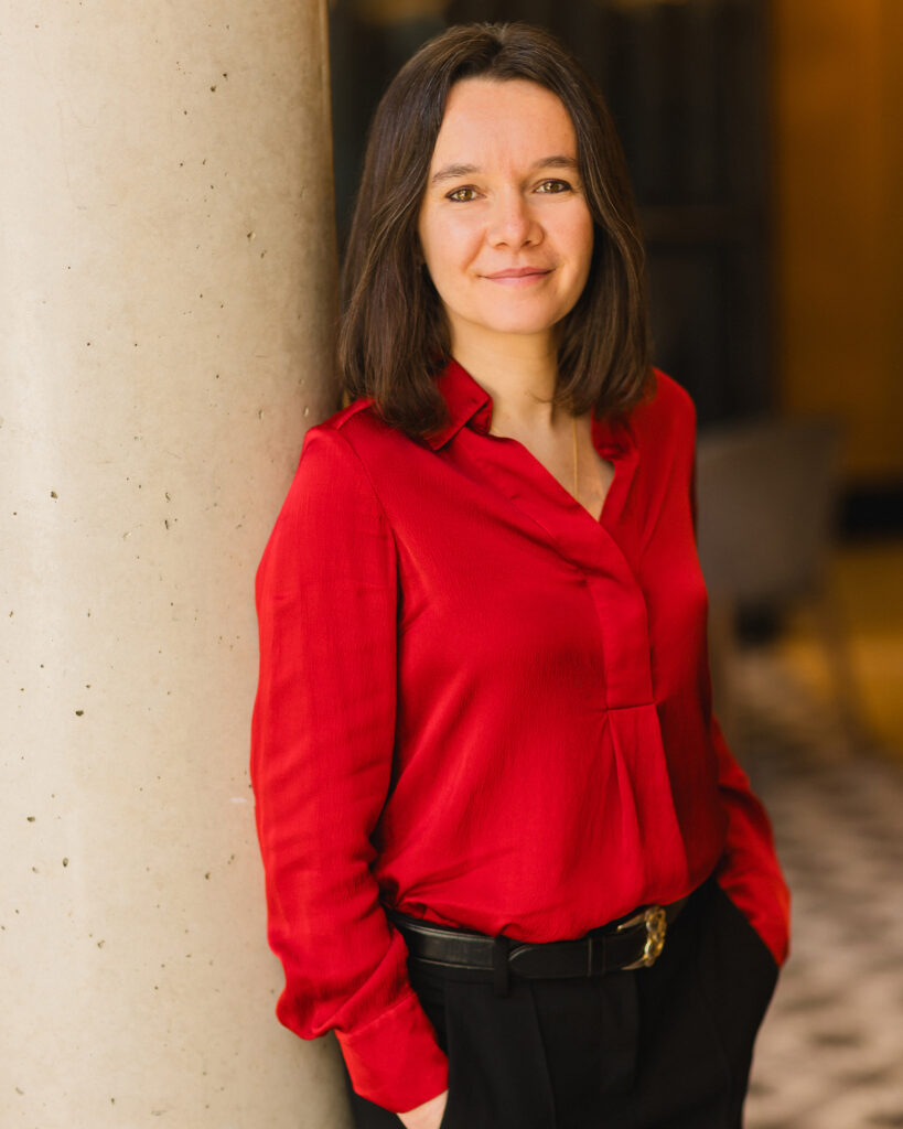 Laurence Galland standing and gently smiling at the camera